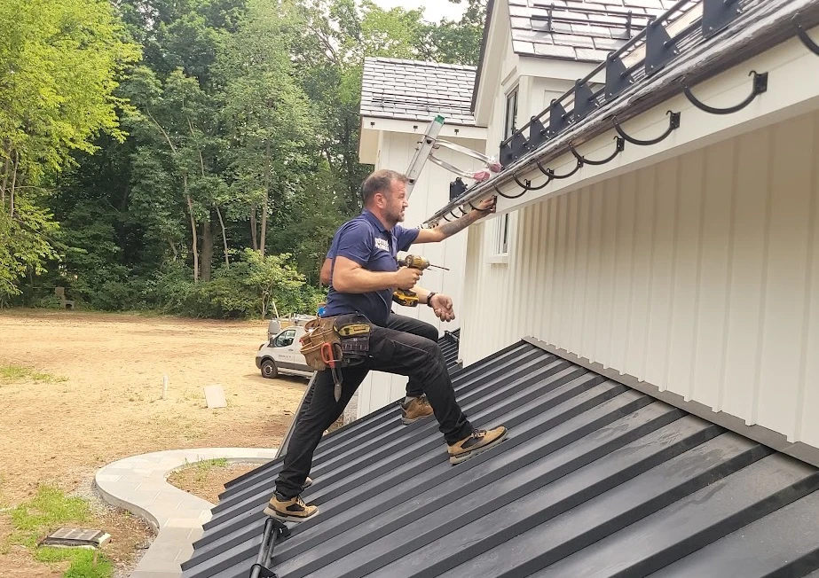 Professional gutter installation in progress - Need: 800x600px image showing technician installing new gutters on residential home