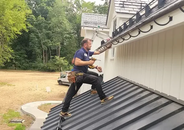 Professional installation team - Need: 600x500px image of experienced technicians installing gutters