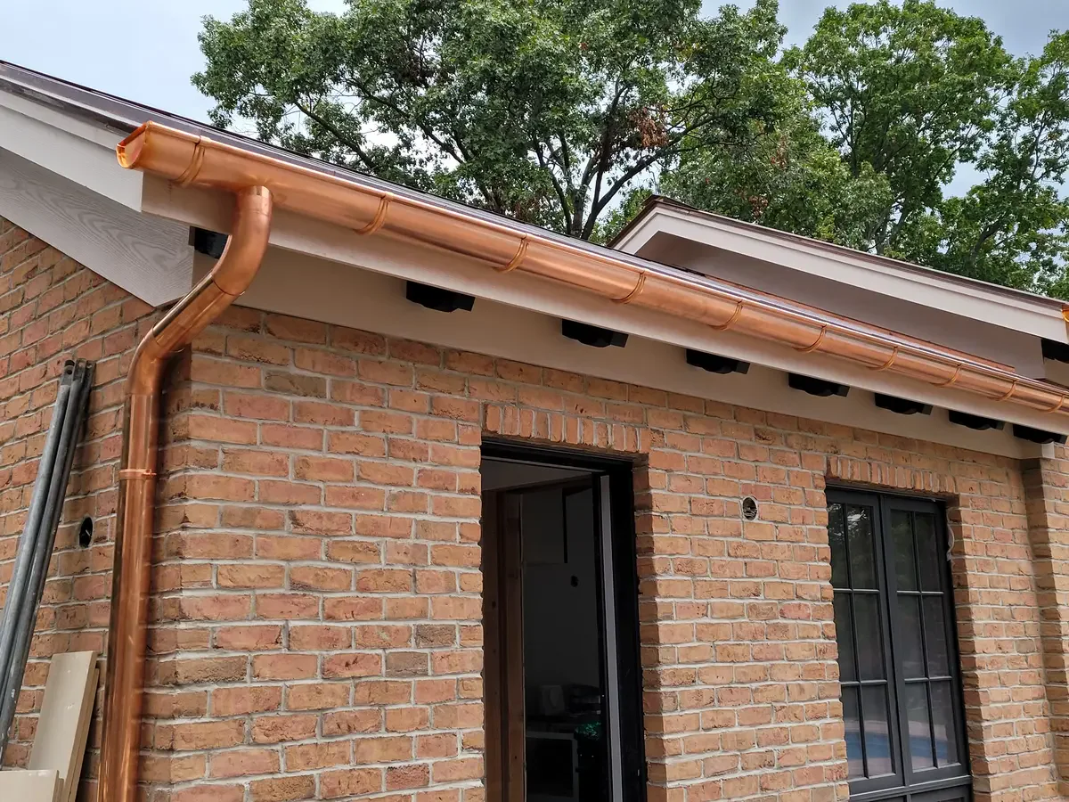 Half-round copper gutters - Need: 400x300px image of half-round copper gutters on historic home